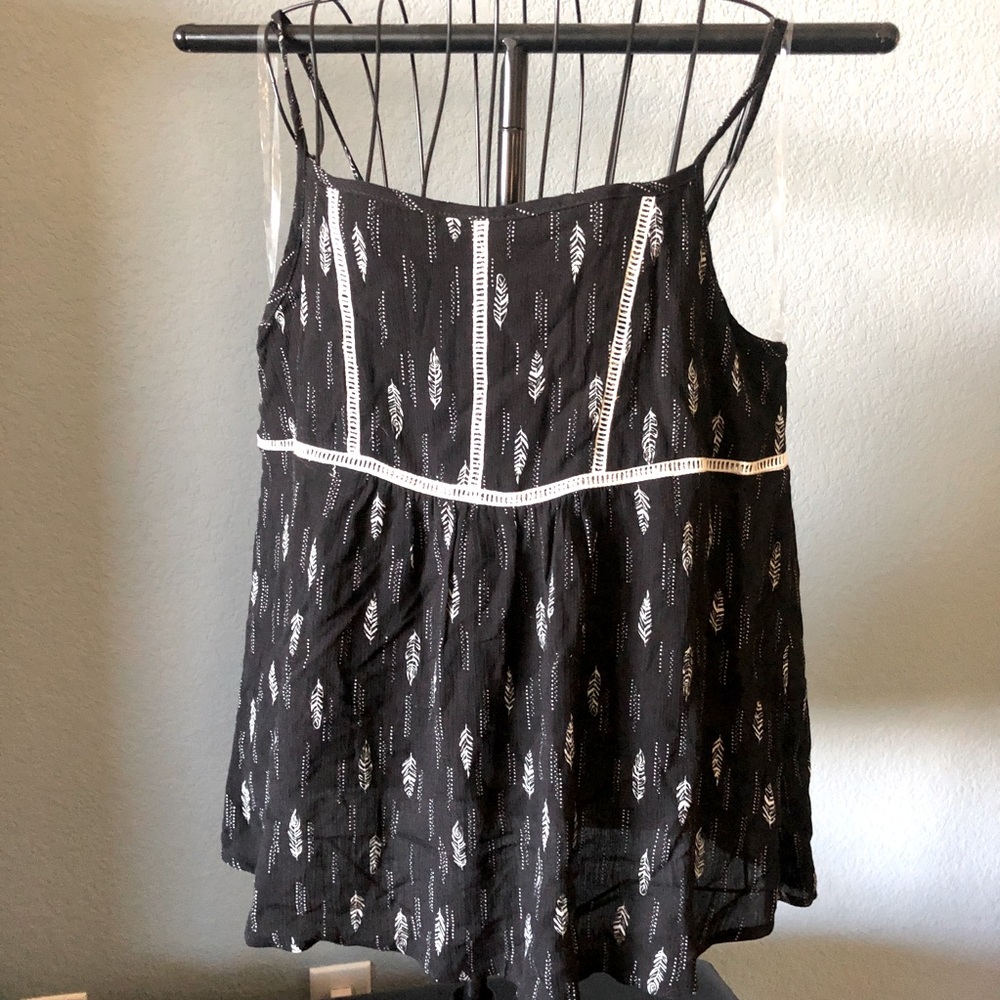 Ces Femme black flowy tank top with white feather print.